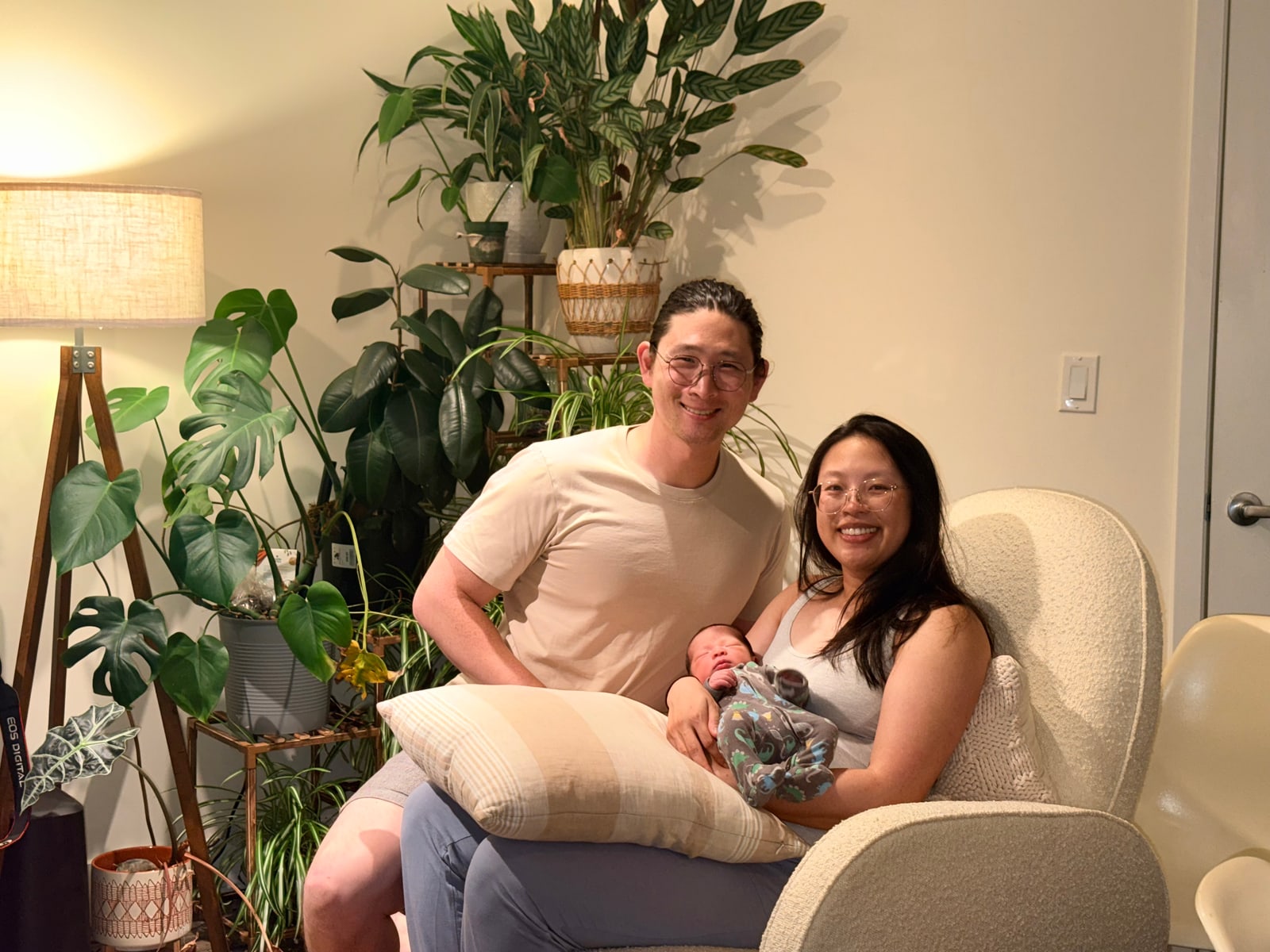 Richard Wei with his family and a baby beside houseplants