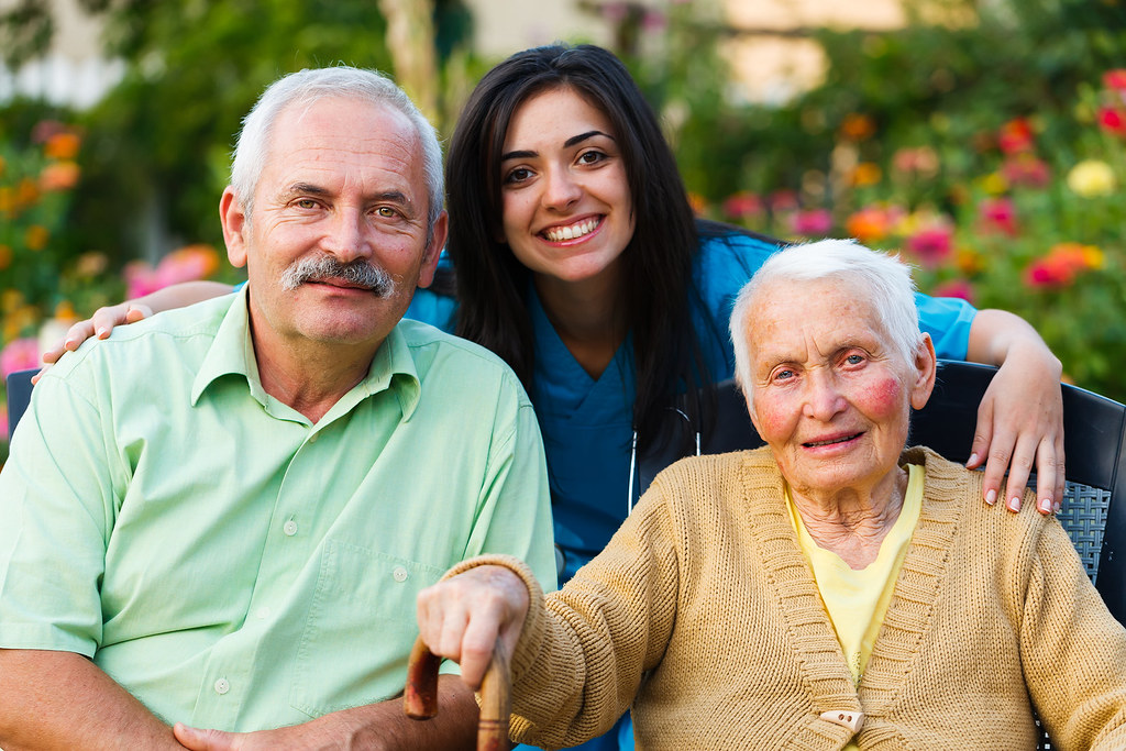 A caregiver in the garden with two of her older clients