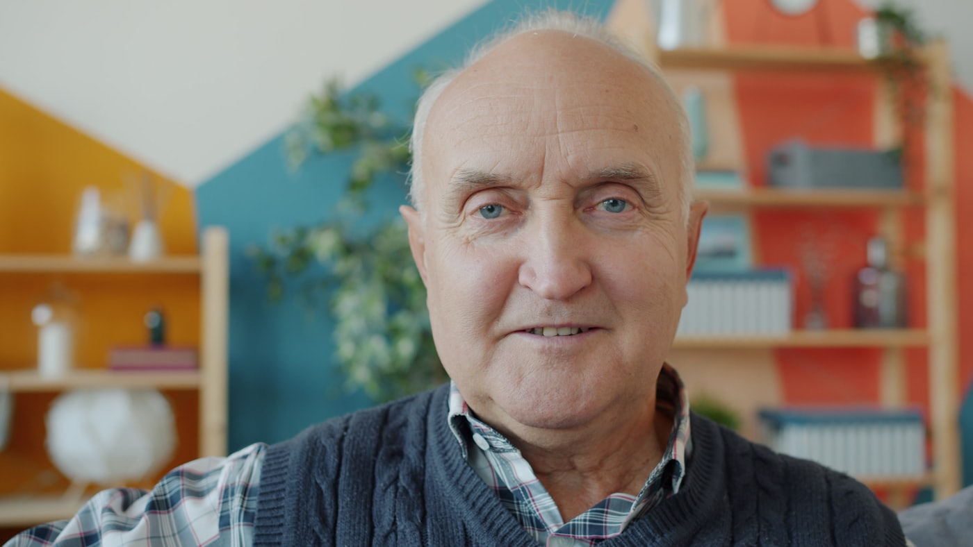 An older man smiling at home
