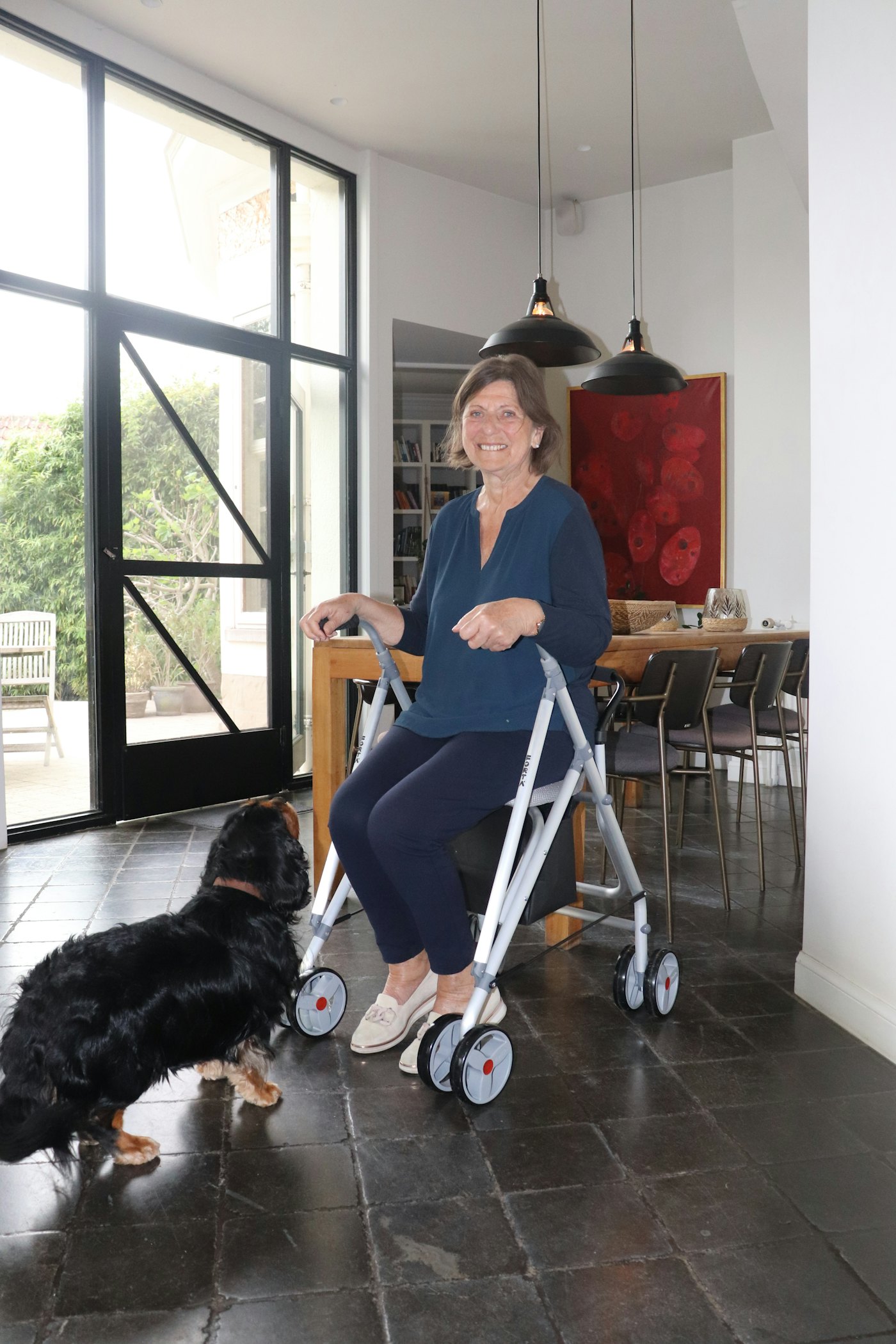 A man at home with his walker and his dog