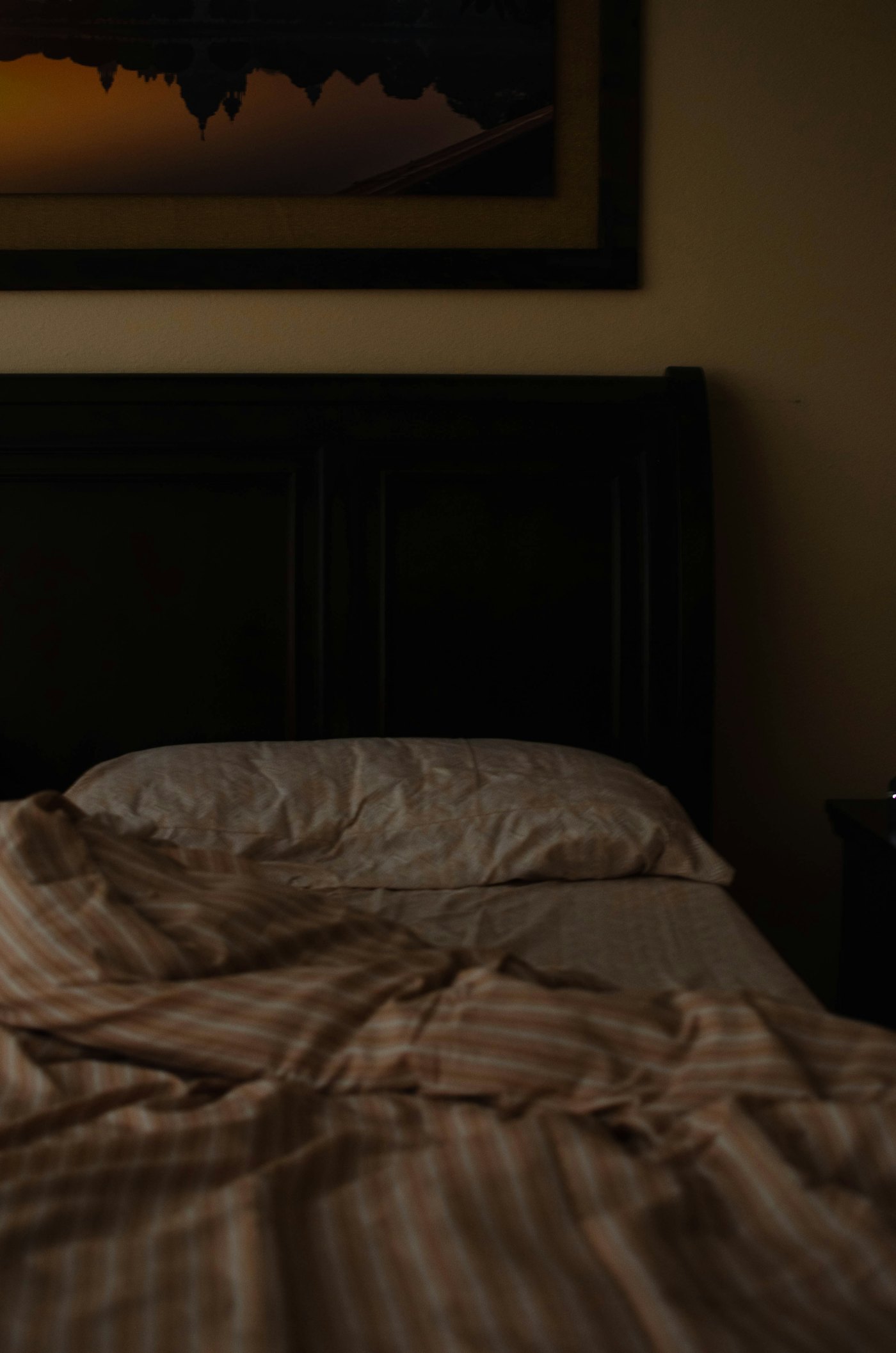 A quiet bedroom at night with warm lamp light