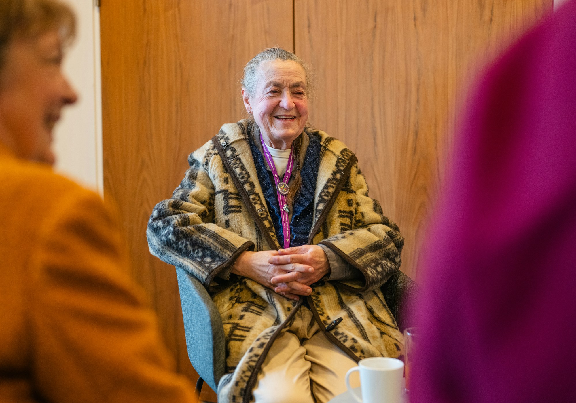 An older woman at home, smiling and relaxed